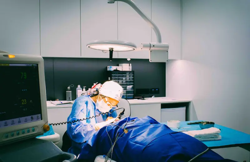 A skilled hair transplant surgeon performing a procedure in a hair transplant clinic.